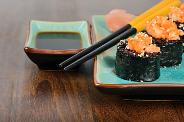 Image showing Baked sushi rolls served on blue plate