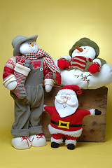 Image showing man with gifts, snowman and santa claus