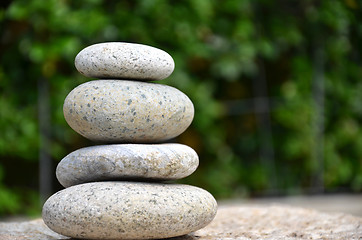 Image showing Stack of zen rocks in garden