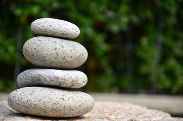 Image showing Stack of zen rocks in garden