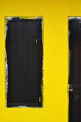 Image showing Wooden window with yellow wall