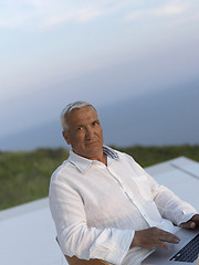 Image showing relaxed senior man on balcony