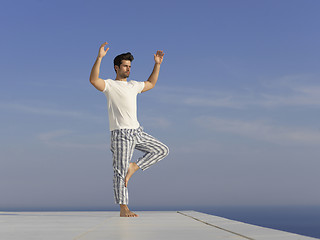 Image showing young man practicing yoga