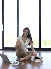 Image showing relaxed young woman at home working on laptop computer