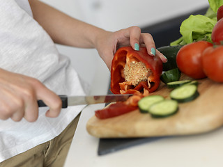 Image showing Young Woman Cooking in the kitchen