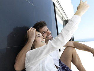 Image showing young couple making selfie together at home