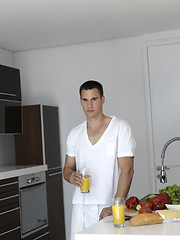 Image showing man cooking at home preparing salad in kitchen