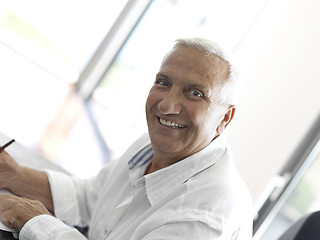 Image showing Portrait of senior man relaxing in sofa