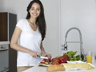 Image showing Young Woman Cooking in the kitchen