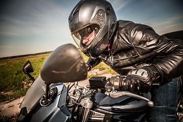 Image showing Biker racing on the road