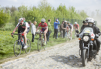 Image showing The Peloton on a Cobblestoned Road