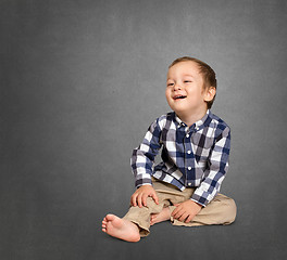 Image showing Cute boy siting on the floor