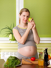 Image showing Pregnant woman on kitchen cooking