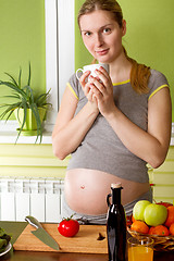Image showing Pregnant woman on kitchen cooking