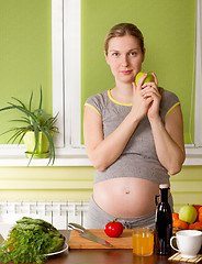 Image showing Pregnant woman on kitchen cooking