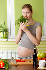 Image showing Pregnant woman on kitchen cooking