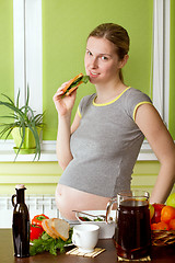 Image showing Pregnant woman on kitchen cooking