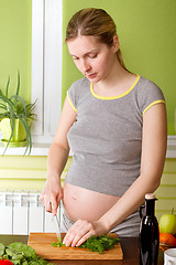 Image showing Pregnant woman on kitchen cooking