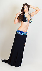 Image showing young woman a performing belly dancing. full height