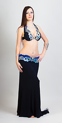 Image showing young woman a performing belly dancing. full height