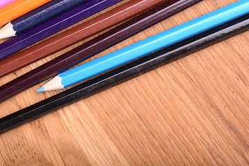 Image showing colored pencils  on wooden background