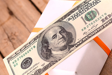 Image showing Holiday bonus.  american money on green gift box