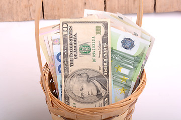 Image showing money set in a basket, dollars, euro and ukrainian money