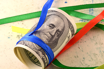 Image showing Bundle of dollars tied with ribbon