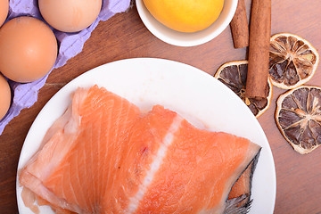 Image showing salmon filet with old lemons and cinnamon