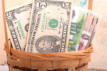Image showing money set in a basket, dollars, euro and ukrainian money