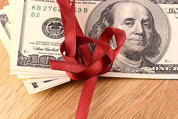 Image showing Bundle of dollars tied with ribbon