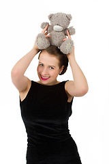 Image showing attractive smiling brunette holding teddy bear