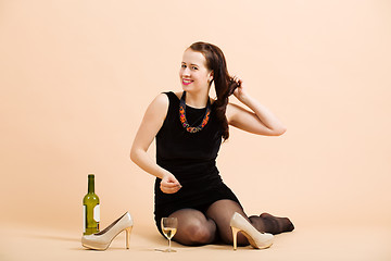 Image showing beautiful young brunette woman holding a glass of white wine