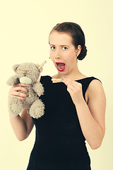 Image showing attractive smiling brunette holding teddy bear