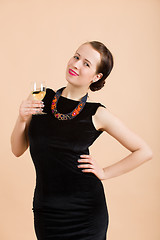 Image showing beautiful young brunette woman holding a glass of white wine