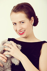 Image showing attractive smiling brunette holding teddy bear