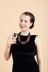 Image showing beautiful young brunette woman holding a glass of white wine