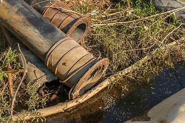 Image showing Rusty metal pipes in the forest