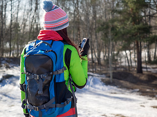 Image showing Hiker tracks his position at the gps