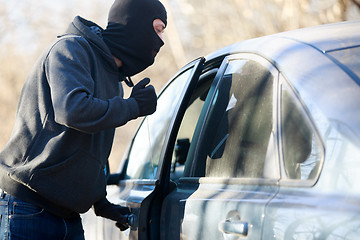 Image showing Thief stealing automobile car at daylight street in city