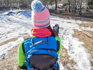 Image showing Hiker tracks his position at the gps