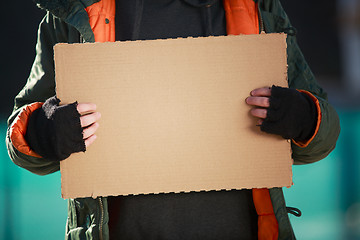 Image showing Homeless man holds blank cardboard for your own text