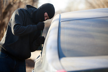 Image showing Thief stealing automobile car at daylight street in city