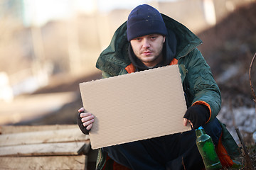 Image showing Homeless man holds blank cardboard for your text