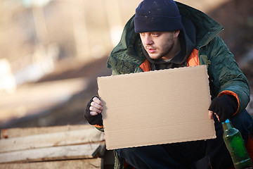 Image showing Homeless man holds blank cardboard for your text