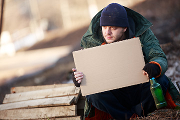 Image showing Homeless man holds blank cardboard for your text