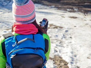 Image showing Hiker tracks his position at the gps