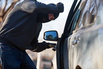 Image showing Thief stealing automobile car at daylight street in city