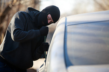 Image showing Thief stealing automobile car at daylight street in city