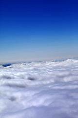 Image showing Mountains under clouds in sun winter day